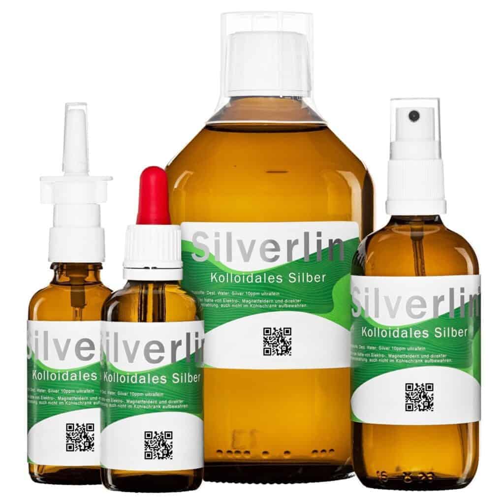 Silverlin® Kolloidales Silber Comfortset mit Braunglasflaschen und verschiedenen Dosieraufsätzen auf hellem Hintergrund.